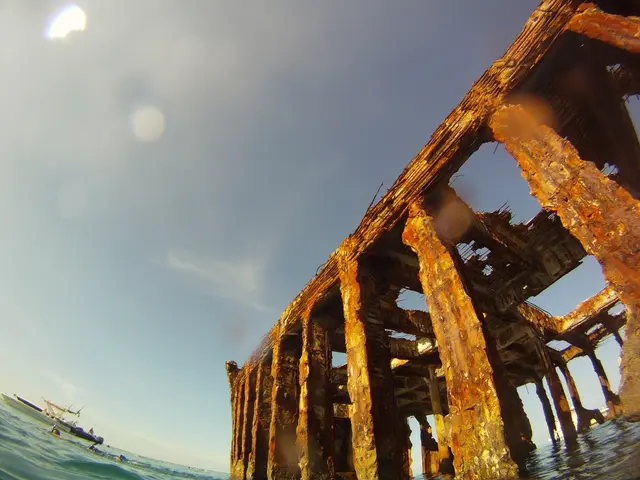 Two individuals, a father and a son, construct extended walls together