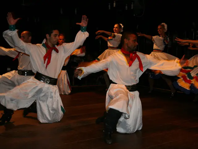 In this picture I can see there are a group of people dancing here and they are wearing white...