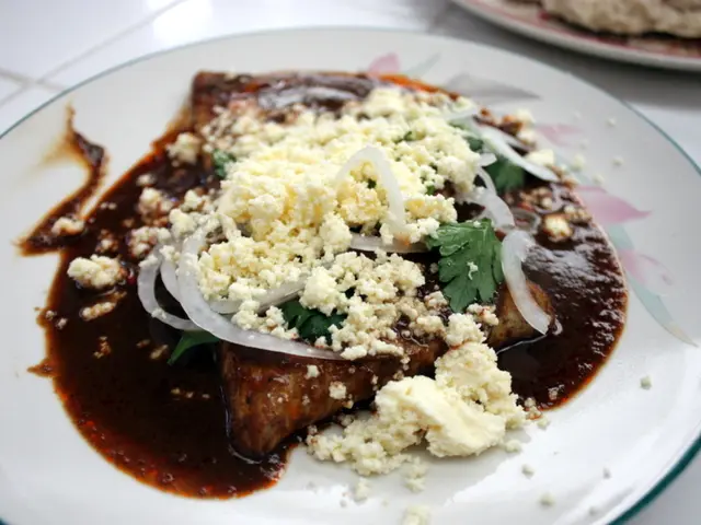 In the image there is a white plate. On the plate there is a food item with onion slices and...