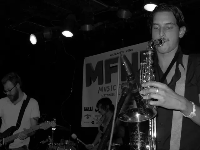 There are 3 people here playing musical instruments. On the roof we can see lights. On the wall...