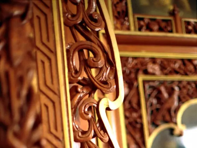 In this image there is a door on which there is some design. On the right side there is a mirror....