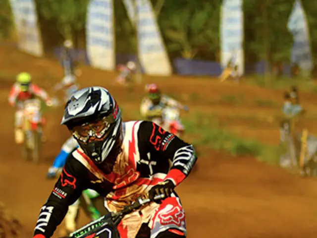 This picture looks like motorbike race. We see few people riding bikes and they wore helmets on...